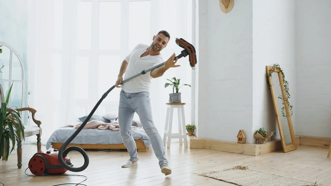 An individual disinfects a workspace using fumigation, wearing full protective gear for safety.